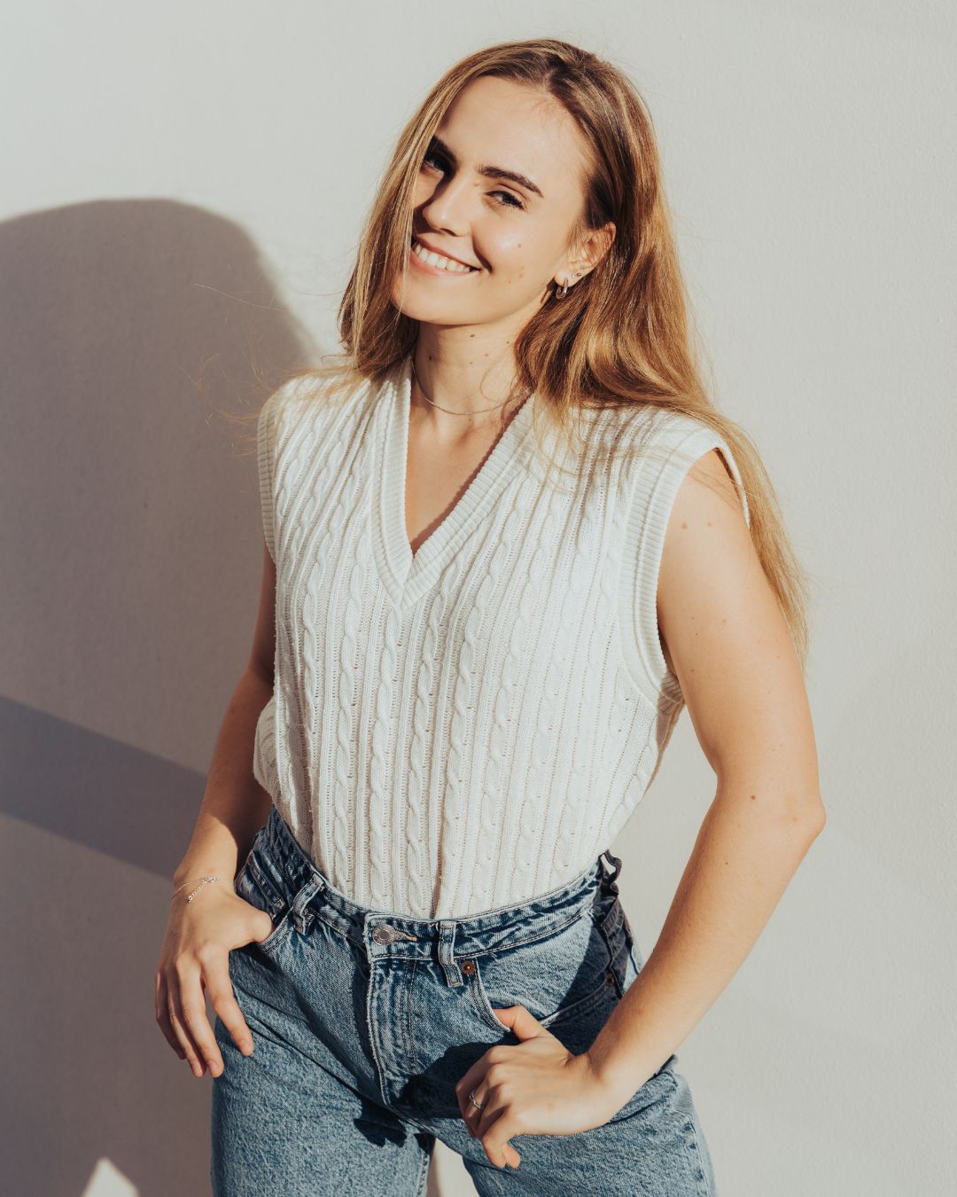 femme-blonde-pull-sans-manches-jean-bleu