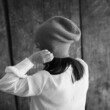 petite-fille-de-dos-met-un-bonnet-en-laine