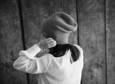 petite-fille-de-dos-met-un-bonnet-en-laine